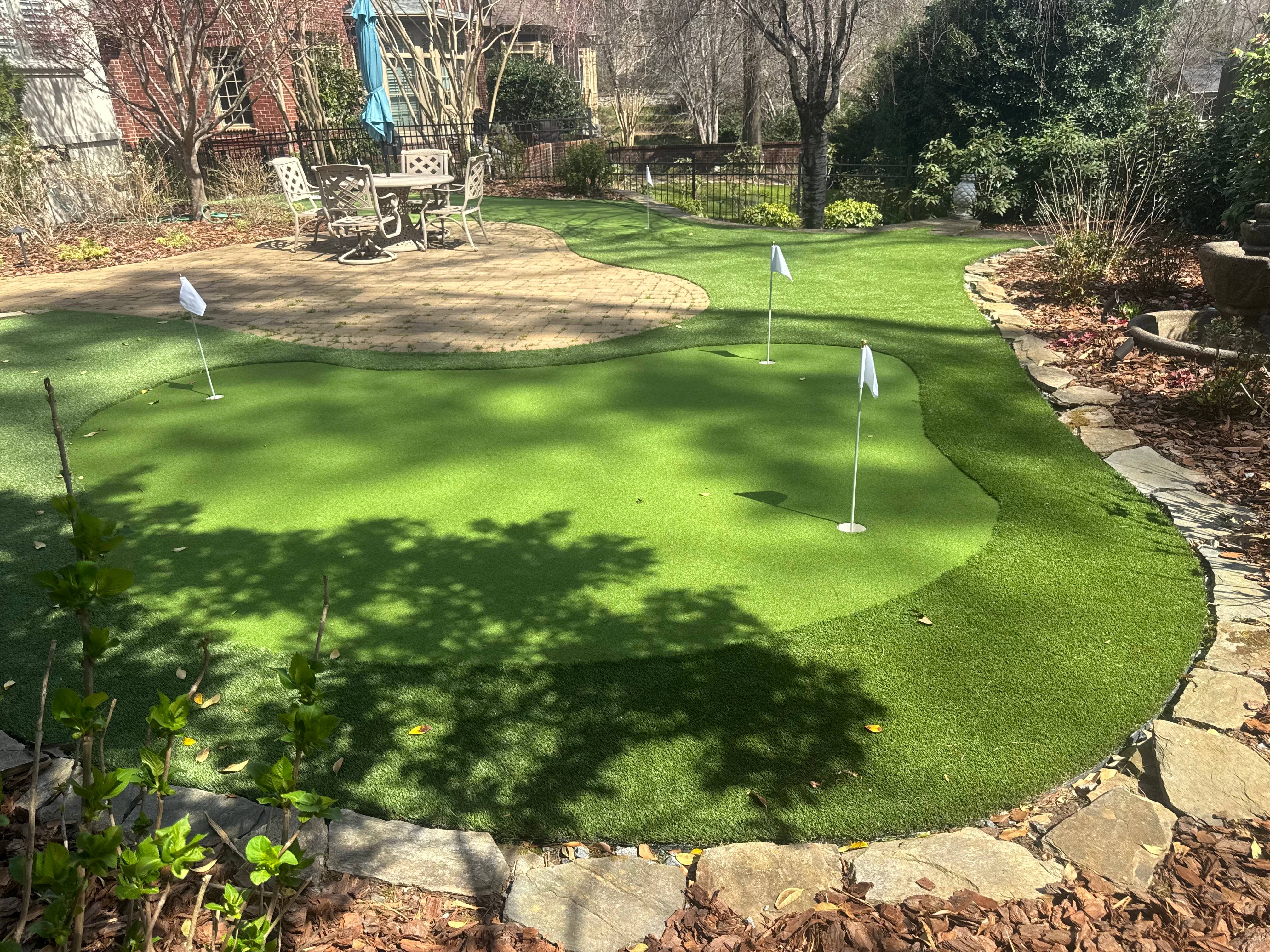 A putting green integrated with beautiful hardscaping